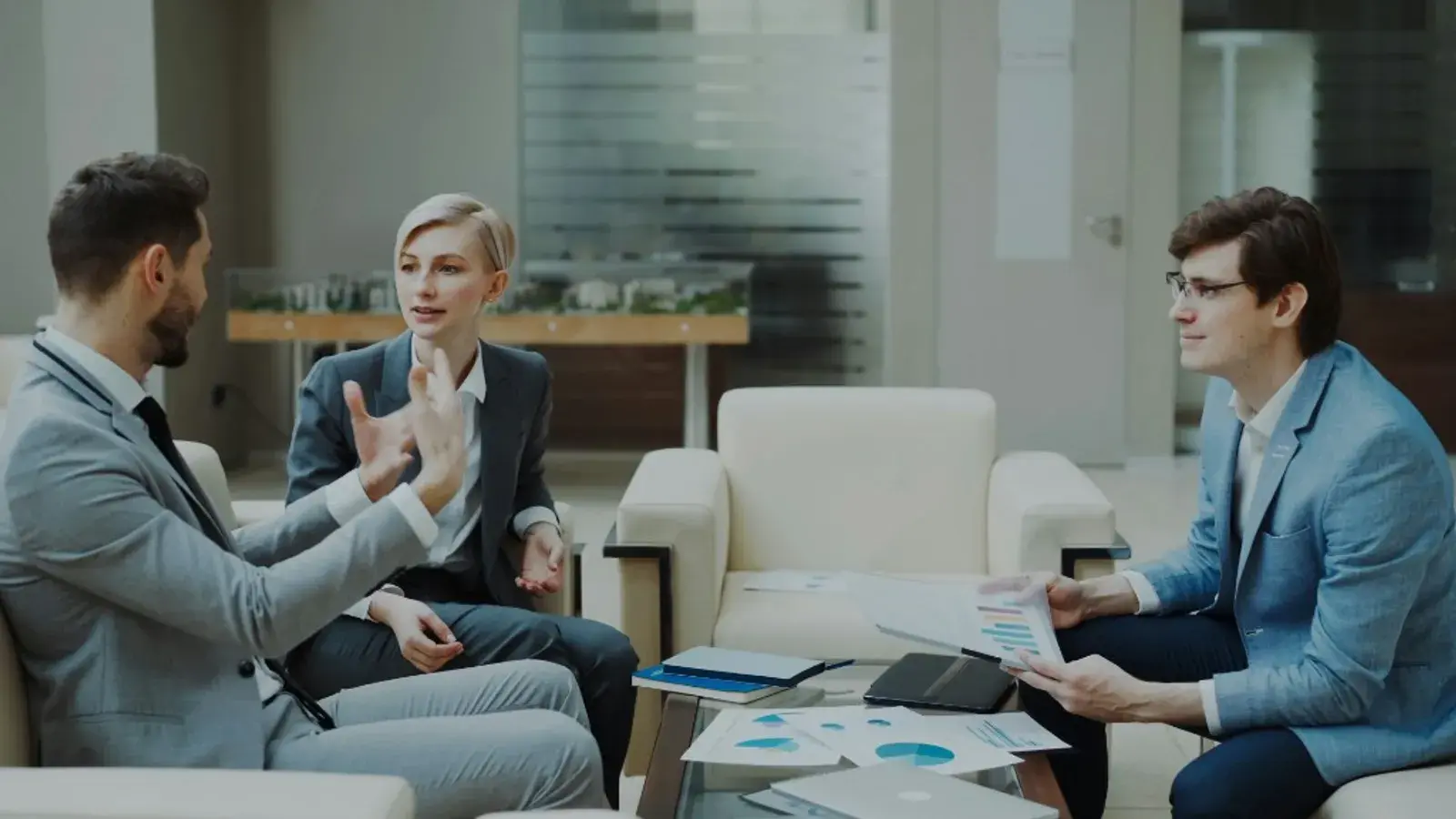 Professionals reviewing financial charts and documents during a business consultation
